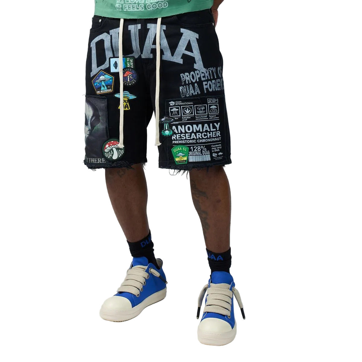 DUAA UFO Black denim shorts in a black colorway featuring an alien and UFO collage print, collegiate DUAA lettering with rhinestones, embroidered patches, and a drawstring waist.