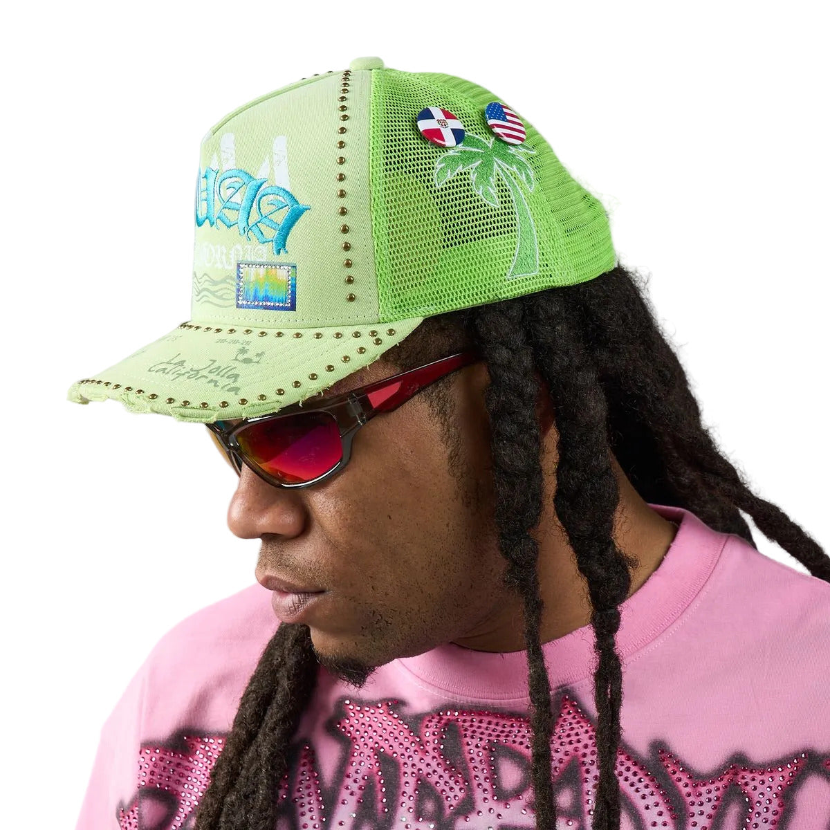 DUAA Wave Hat with neon green front, mesh back, Old English embroidery, blue octopus side detail, gold stud trim, and distressed snapback brim.