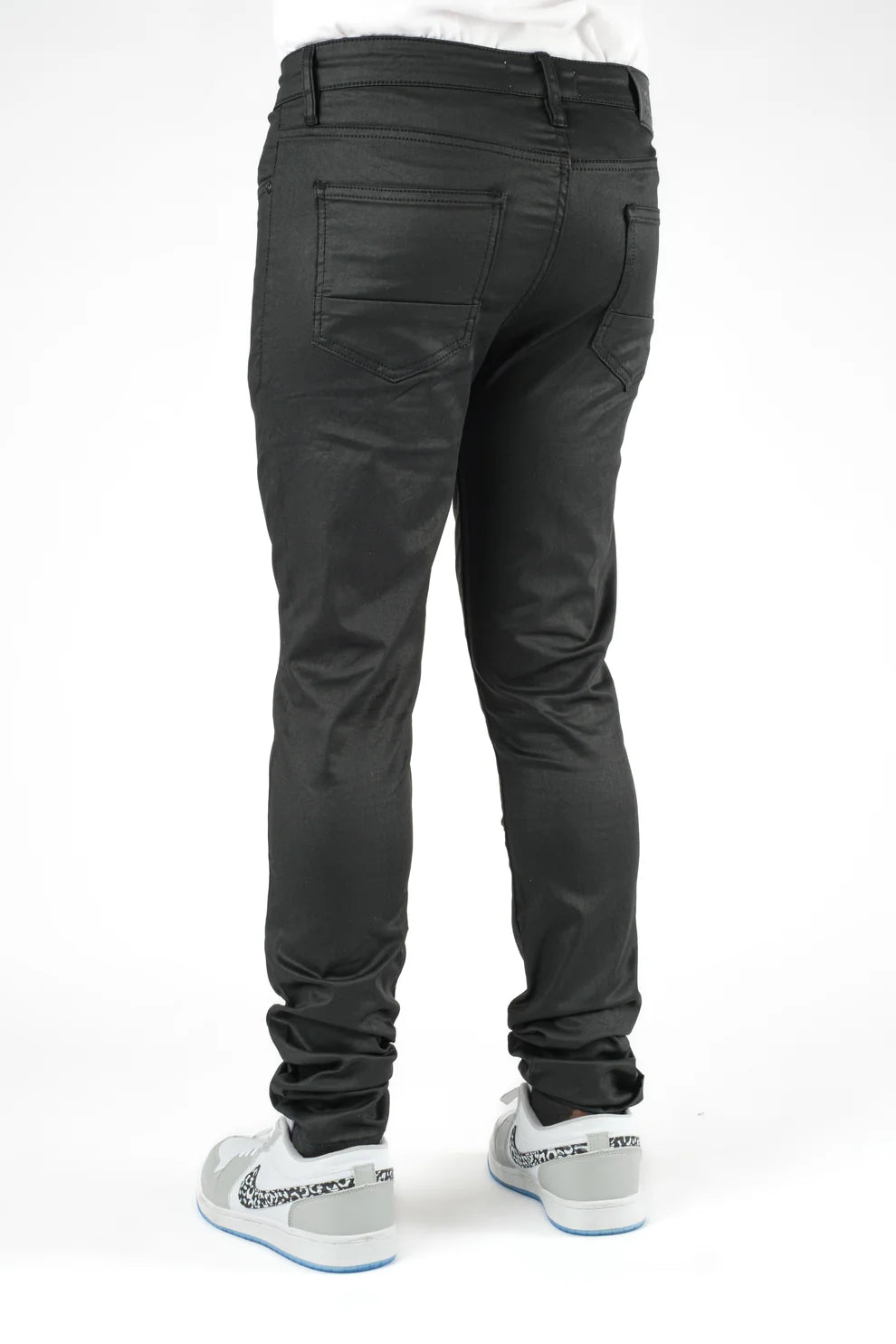 Black pants worn by a person on a white background