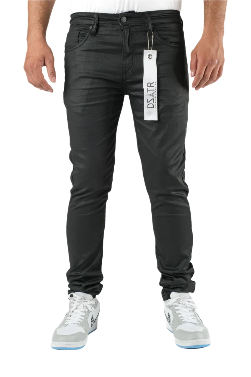 Person wearing black jeans with a visible brand tag on a white background