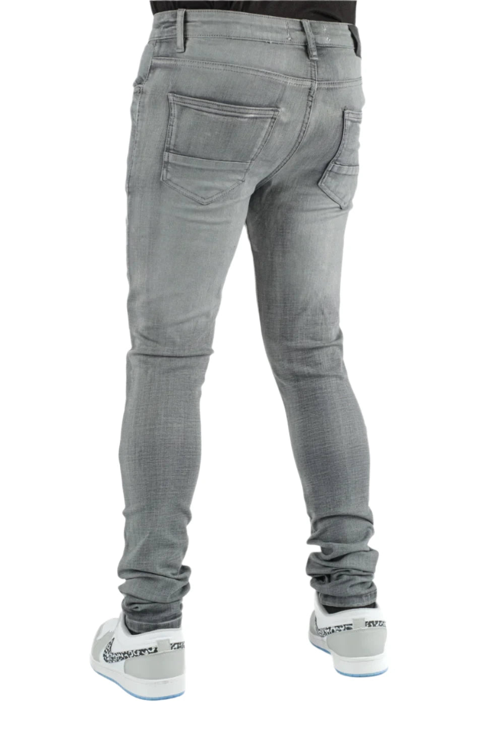 Gray jeans worn by a person on a white background