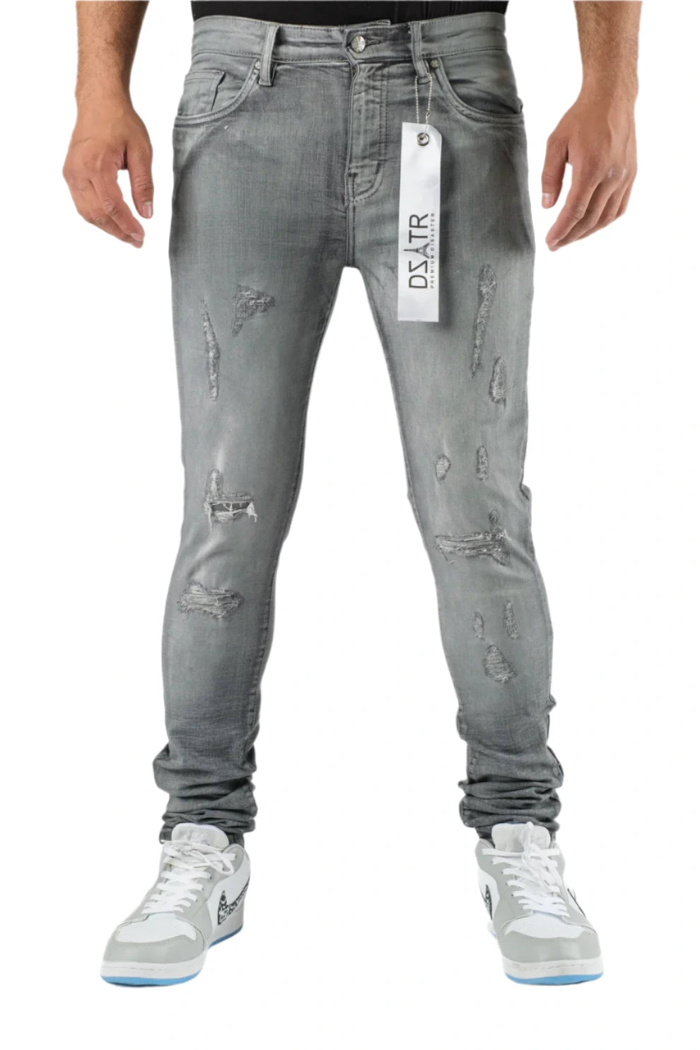 Gray distressed jeans with a brand tag on a white background