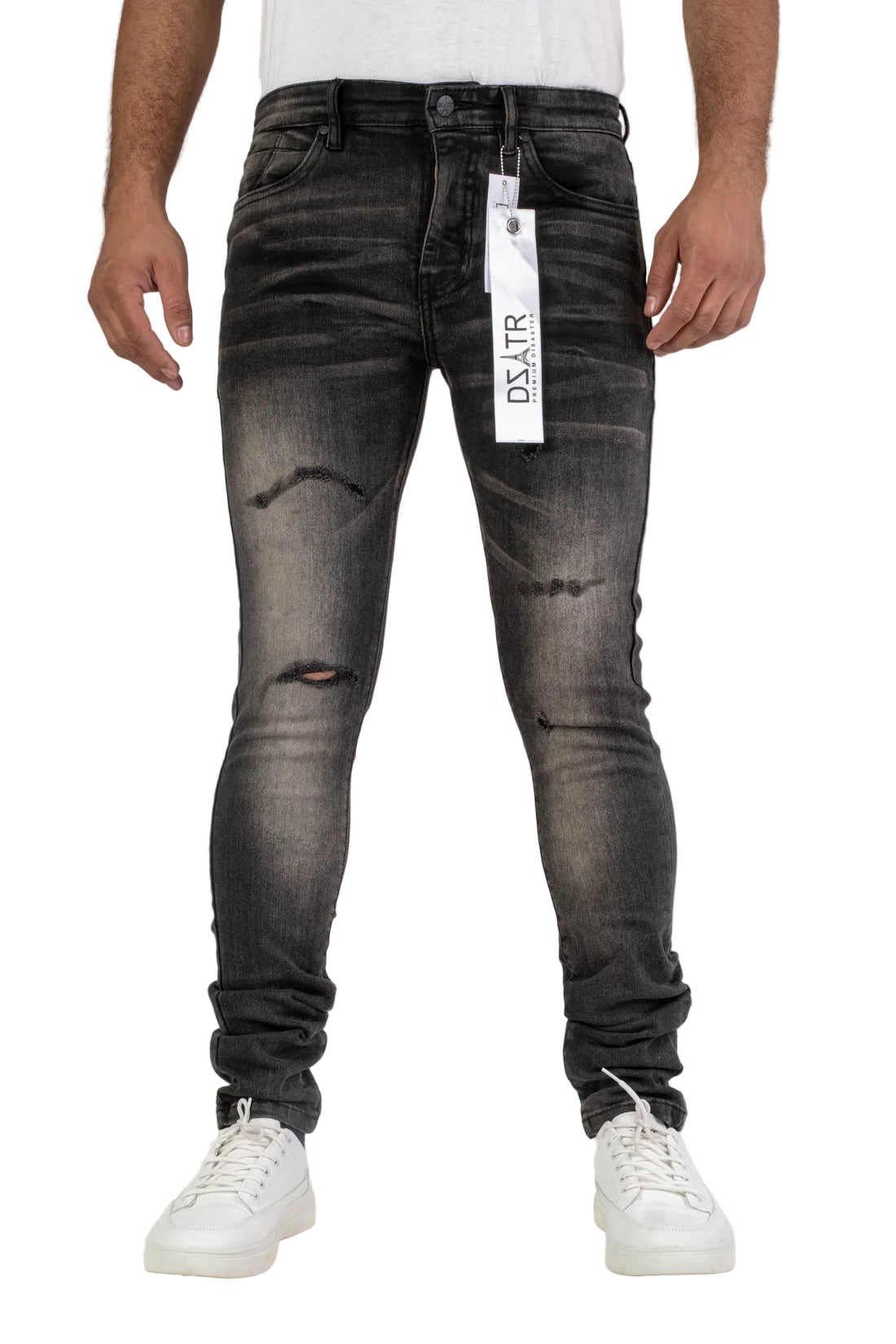 Person wearing black distressed jeans with a visible brand tag on a white background