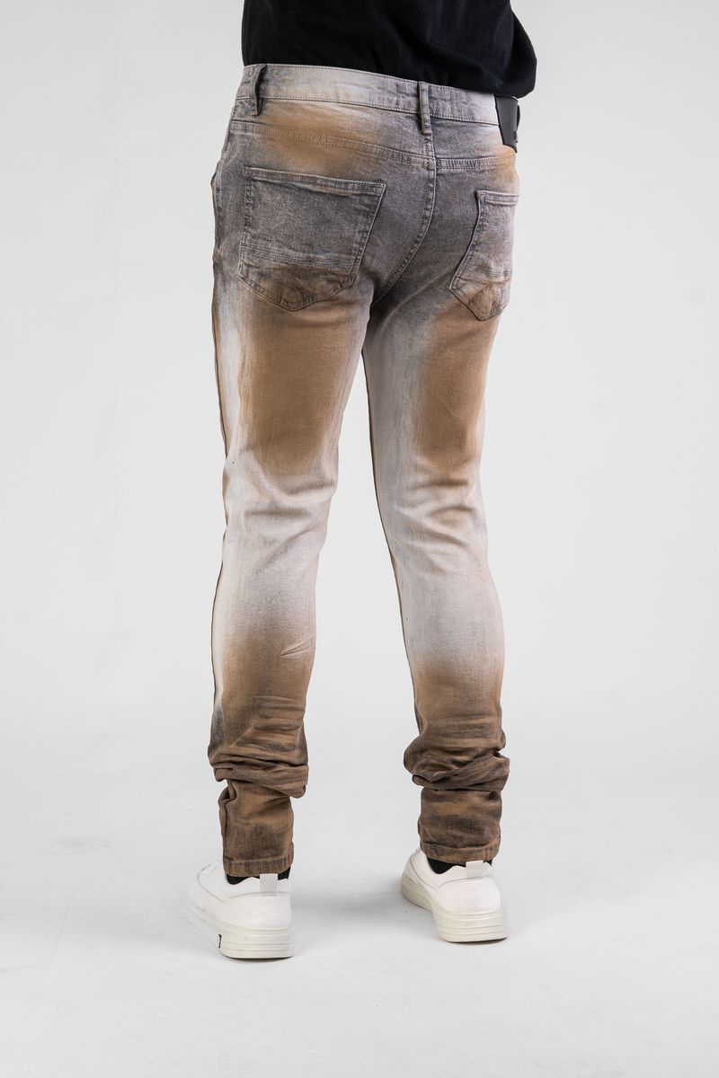 Gradient jeans with brown to gray color transition on a white background
