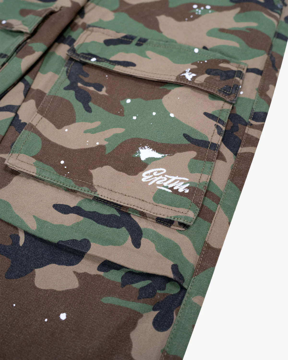 Neo Cargo Pants in printed duck canvas with relaxed fit, cargo pockets, paint splatter accents, and metal logo hardware