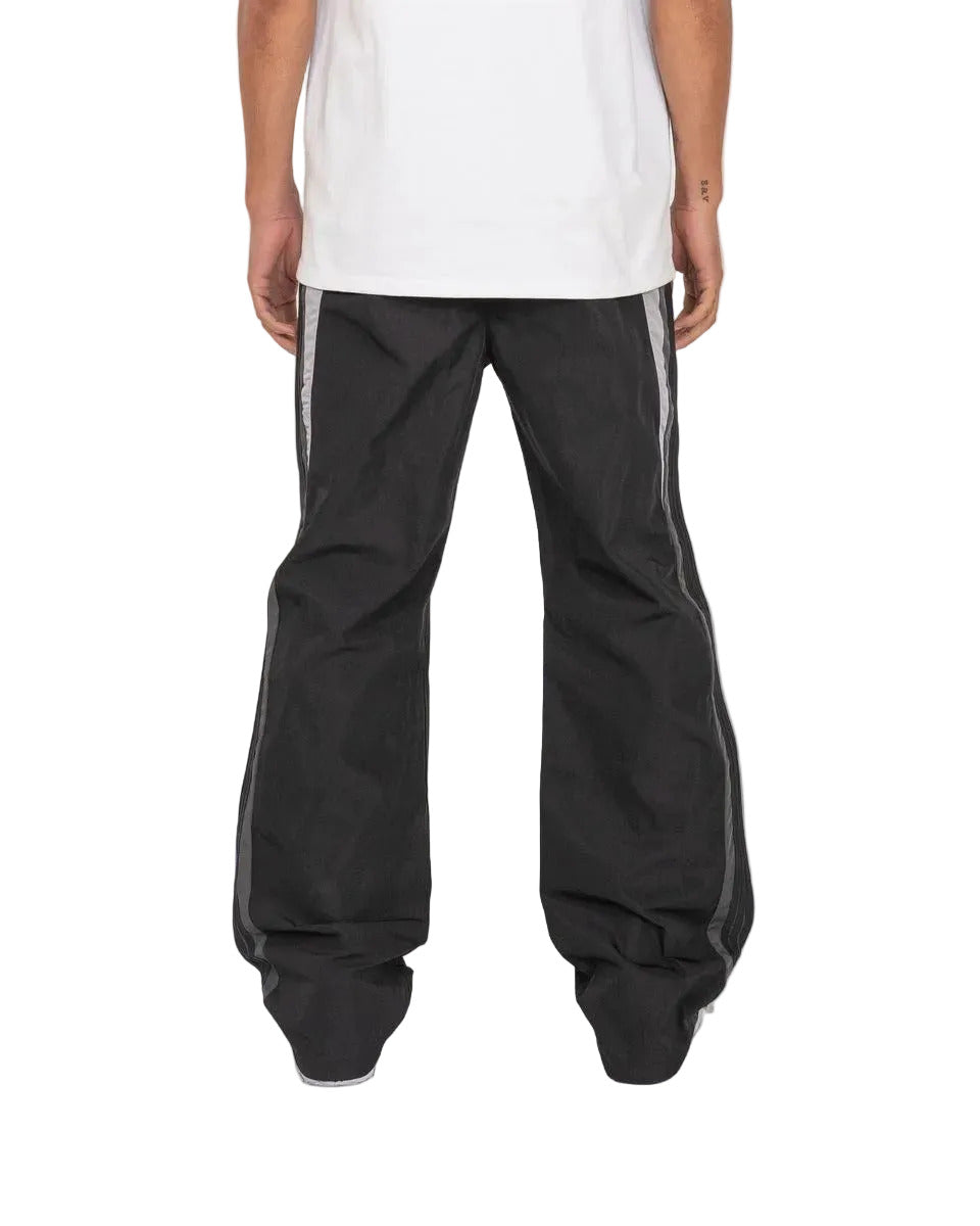 Baladin black pants with bold color blocking, tonal tape details, elastic waistband with adjustable cord and toggles, and front and back pockets