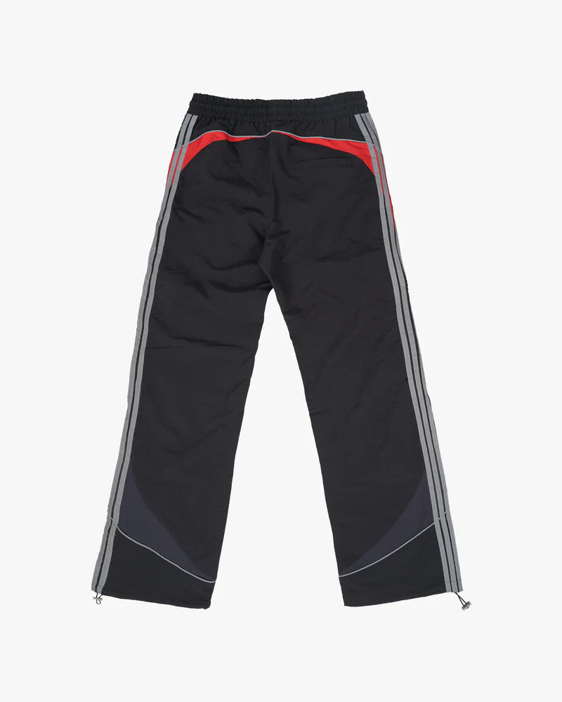 Solar Pants made from ripstop nylon with sun-inspired ombre panels, 3M reflective trims, elastic waistband, and relaxed fit