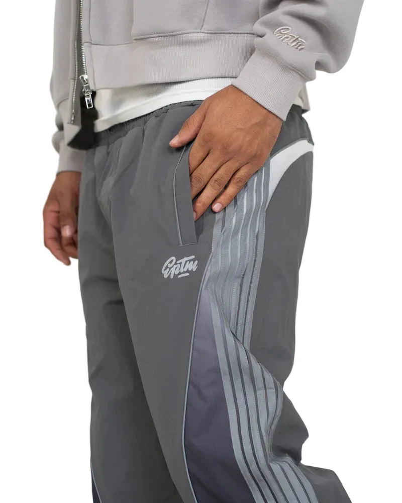 Solar Pants made from ripstop nylon with sun-inspired ombre panels, 3M reflective trims, elastic waistband, and relaxed fit