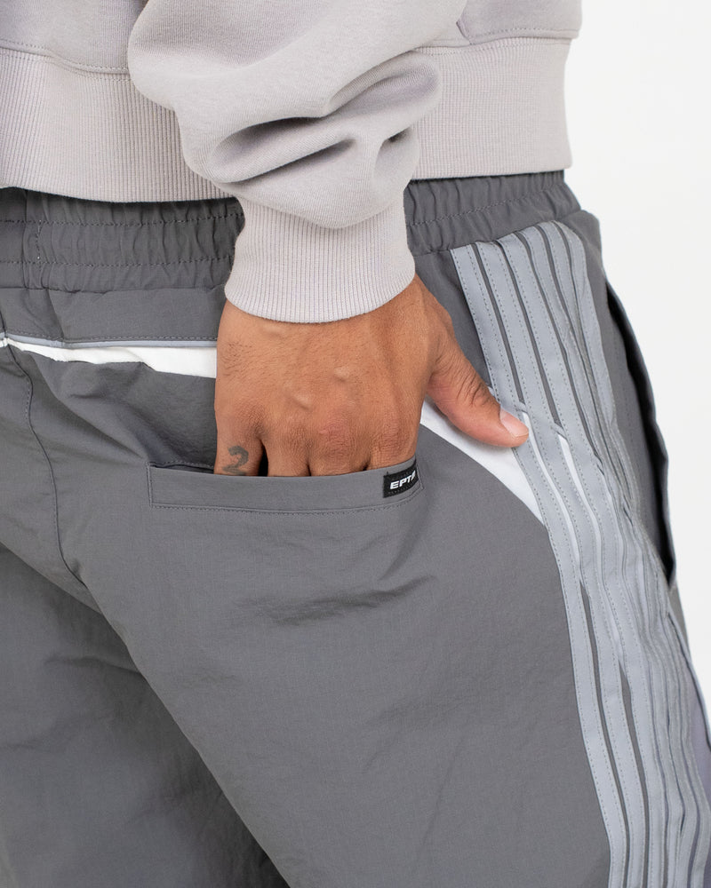 Solar Pants made from ripstop nylon with sun-inspired ombre panels, 3M reflective trims, elastic waistband, and relaxed fit