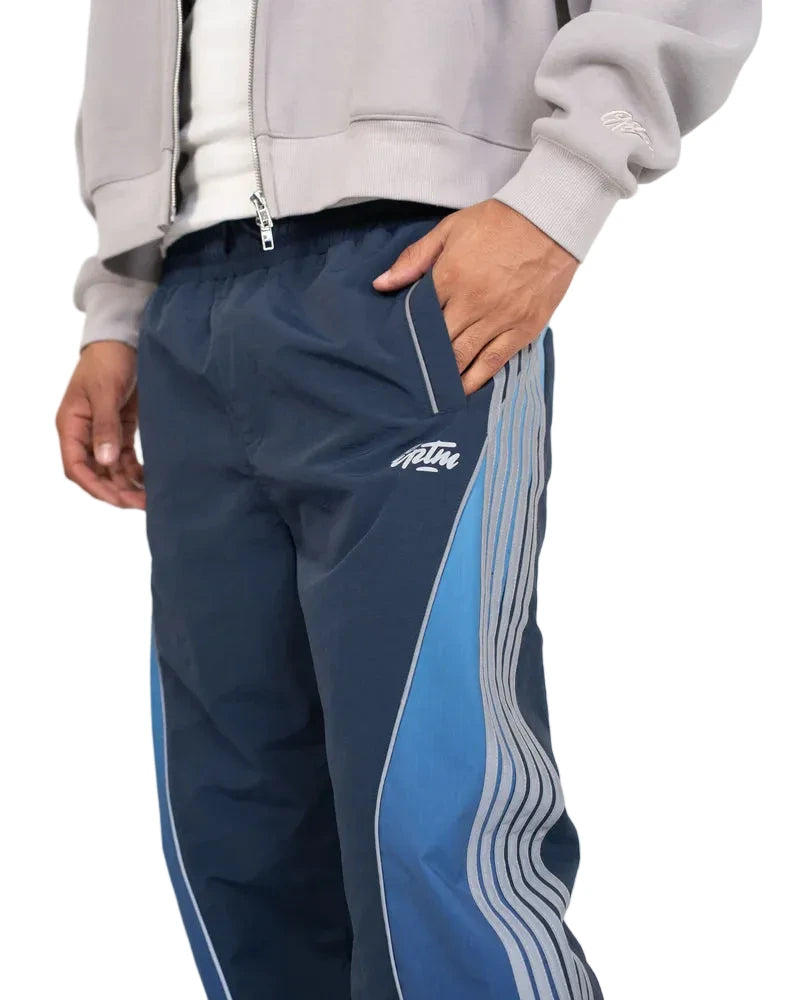 EPTM Solar Pants in Dusk made from ripstop nylon with sun-inspired ombre panels, 3M reflective trims, elastic waistband, and relaxed fit