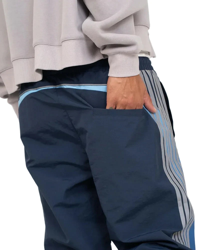 EPTM Solar Pants in Dusk made from ripstop nylon with sun-inspired ombre panels, 3M reflective trims, elastic waistband, and relaxed fit