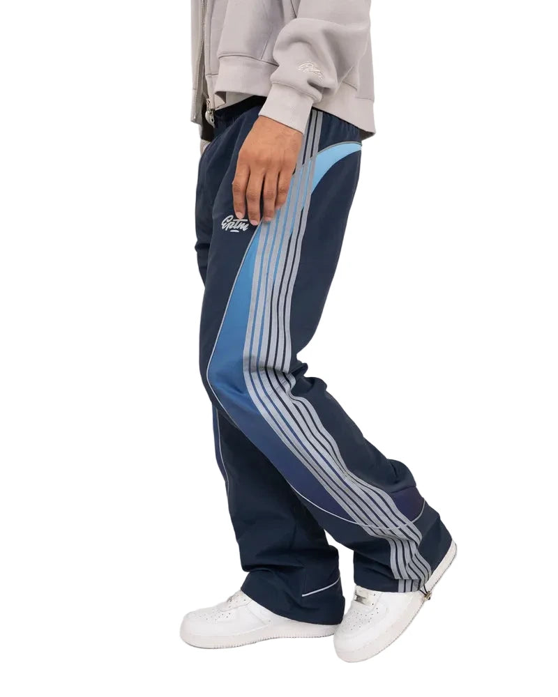 EPTM Solar Pants in Dusk made from ripstop nylon with sun-inspired ombre panels, 3M reflective trims, elastic waistband, and relaxed fit