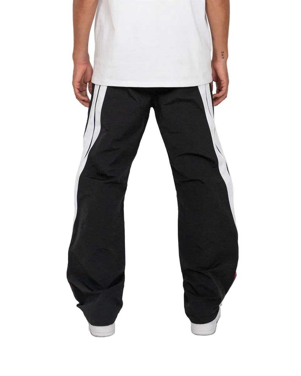 Noir pants with color-block panels, piping details, and lightweight nylon ripstop fabric for modern streetwear style