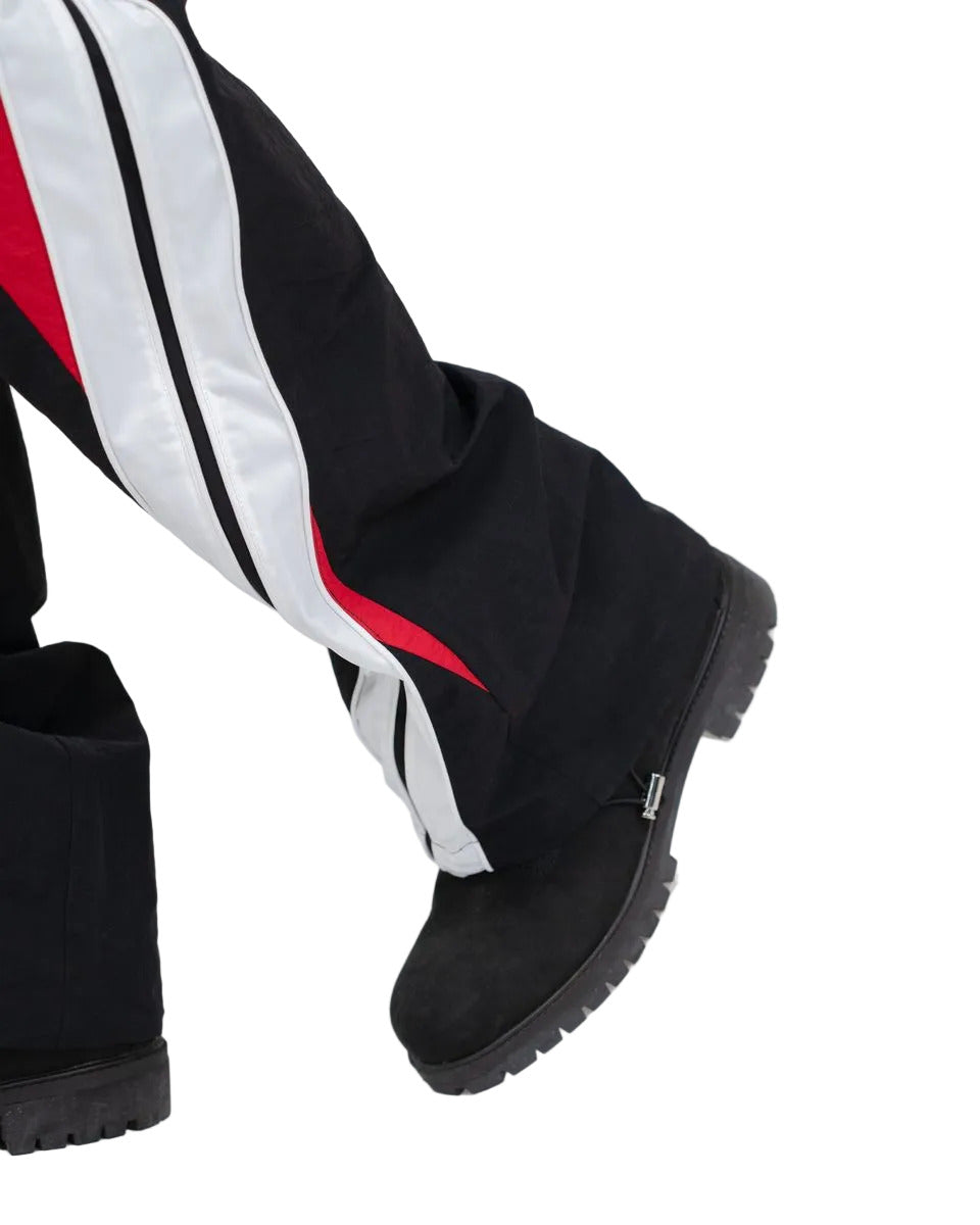 Noir pants with color-block panels, piping details, and lightweight nylon ripstop fabric for modern streetwear style