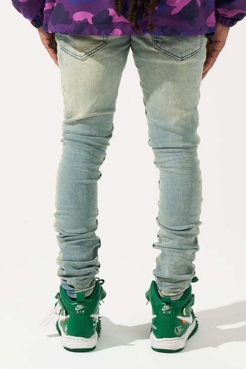 SERENEDE® ESPRESSO Jeans in earth core vintage wash with fitted construction, fading, premium stretch, and embroidered [S]® logo.