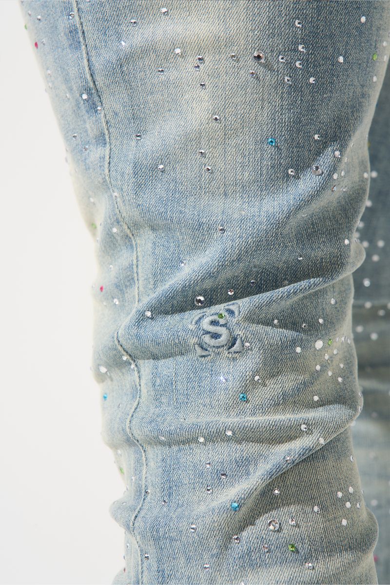 SERENEDE® Franchise fitted denim jeans in vintage earth blue wash with multi-colored hot-fix crystals and branded detailing.