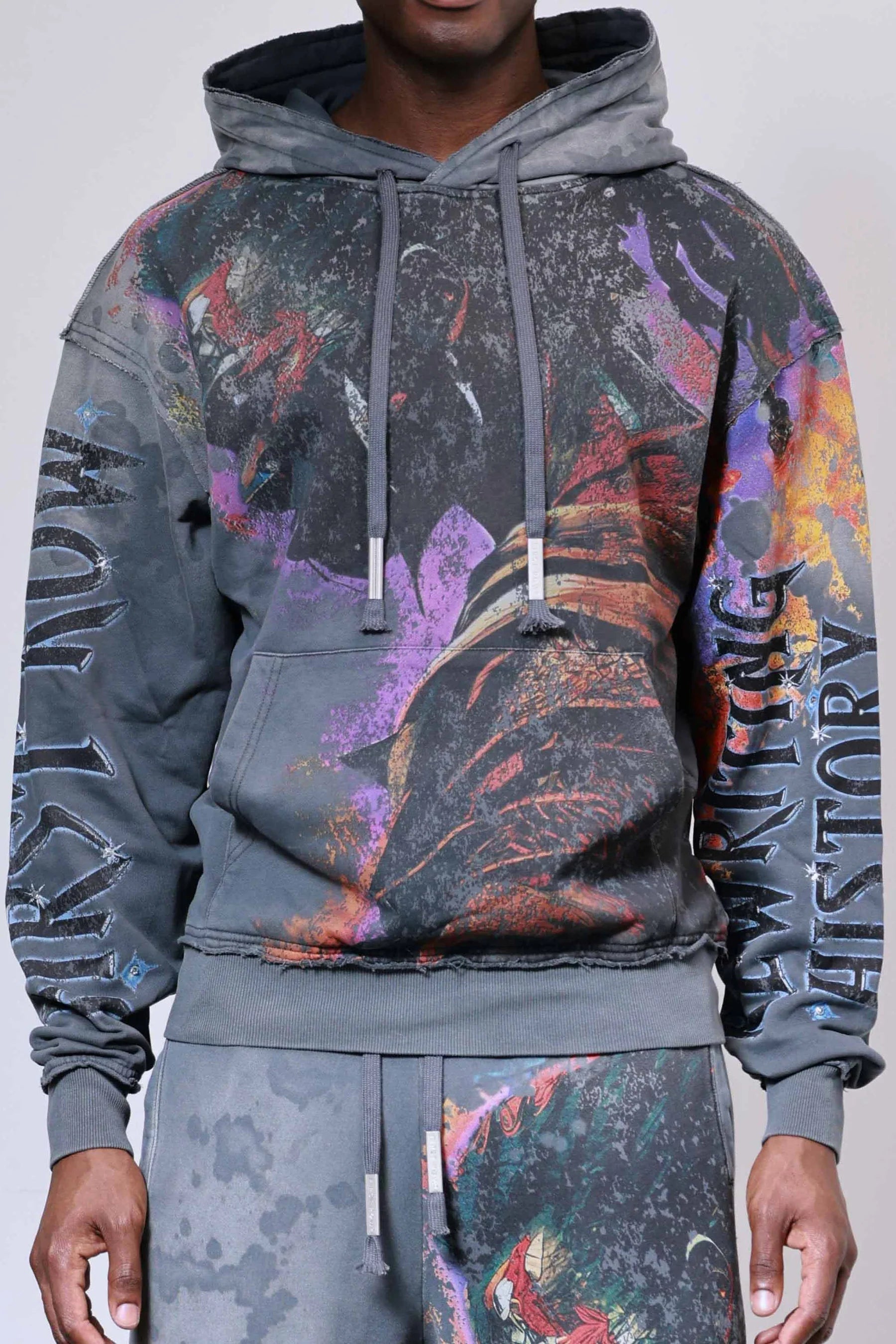 Firstrow ANCESTRAL CALL SPIRIT WALKER Hoodie in heavy washed fabric with rhinestones, oversized fit, raw edge hem, and kanga pocket.