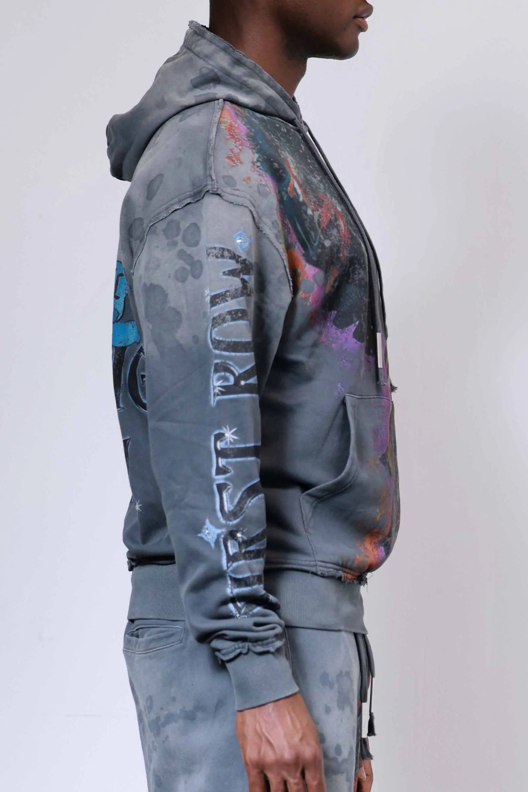 Firstrow ANCESTRAL CALL SPIRIT WALKER Hoodie in heavy washed fabric with rhinestones, oversized fit, raw edge hem, and kanga pocket.