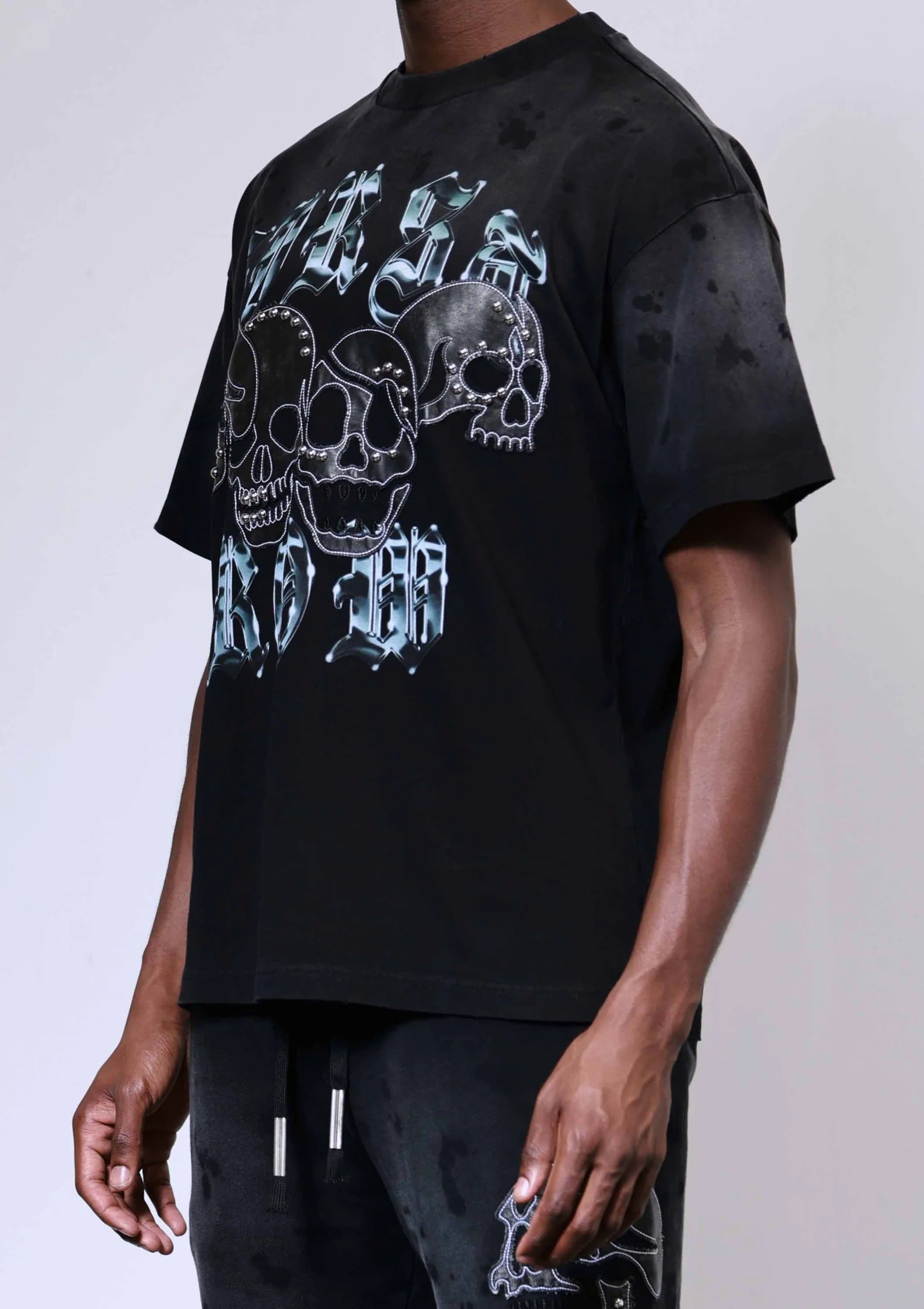 "First Row Wake Up and Be Fierce appliqué graphic tee with embroidery, stud details, and bleach splash wash effect."