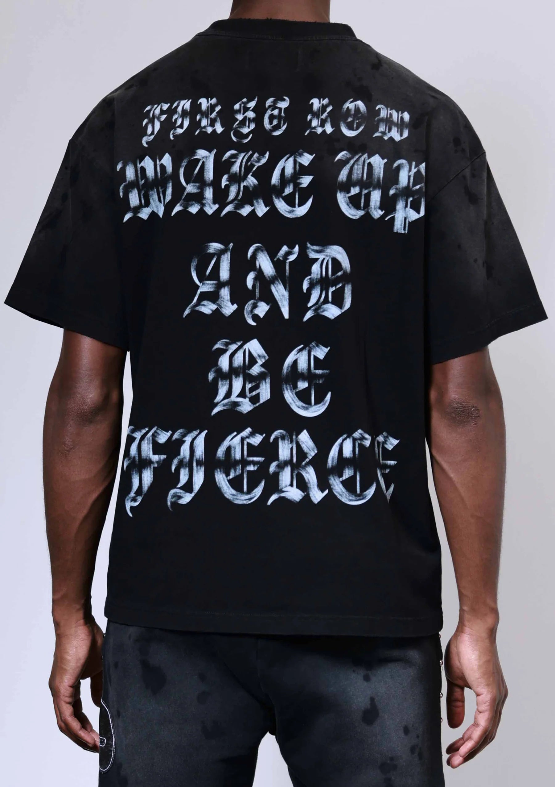 "First Row Wake Up and Be Fierce appliqué graphic tee with embroidery, stud details, and bleach splash wash effect."