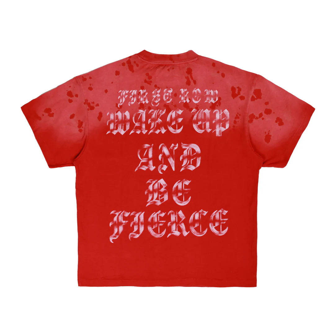 "First Row Wake Up And Be Fierce Applique Tee in red with applique embroidery, stud accents, and bleach splash wash effect."