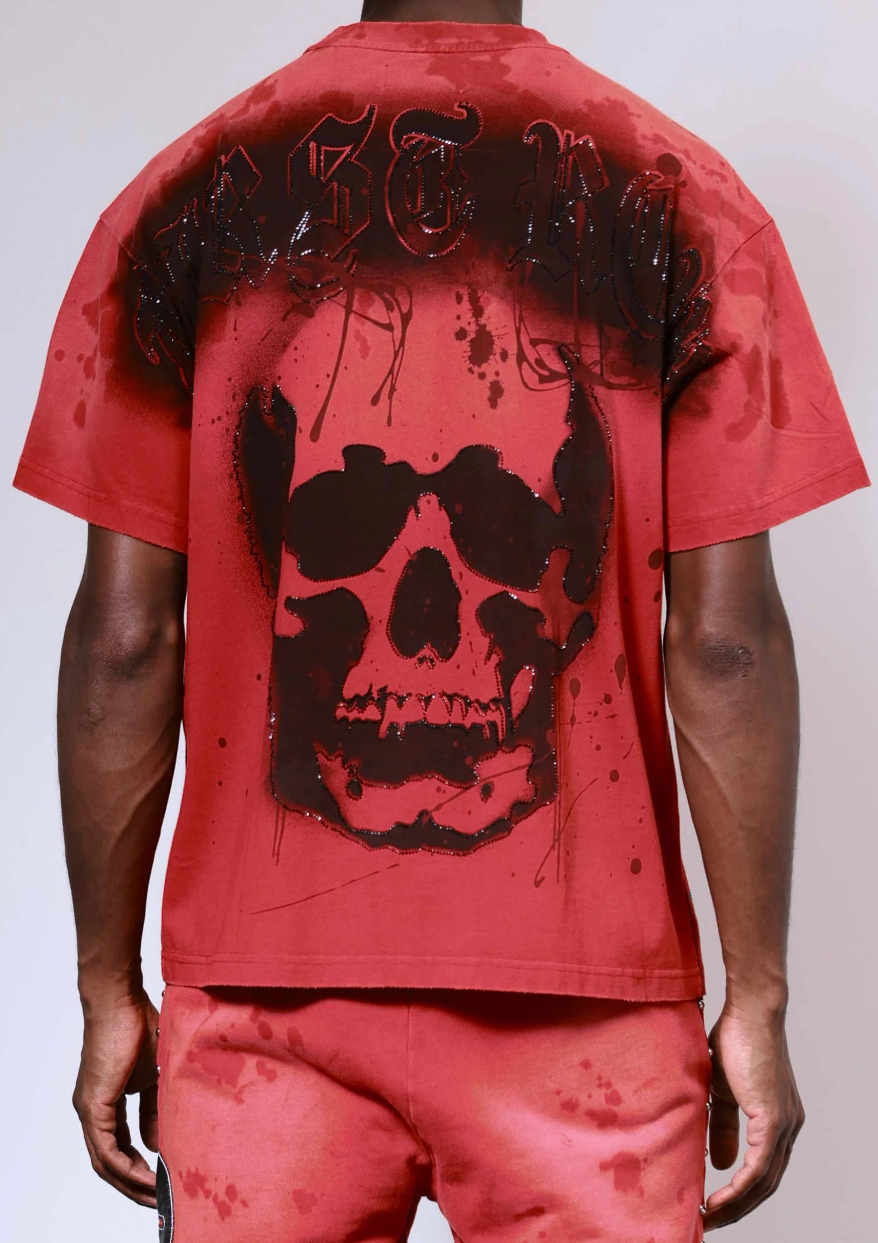 "First Row Wake Up And Be Fierce Applique Tee in red with applique embroidery, stud accents, and bleach splash wash effect."