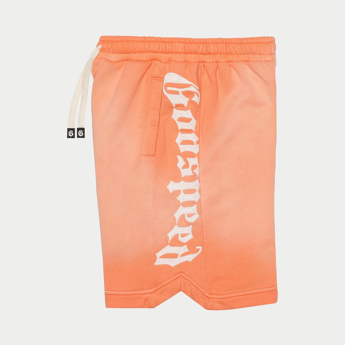 Orange shorts with a logo on a light gray background