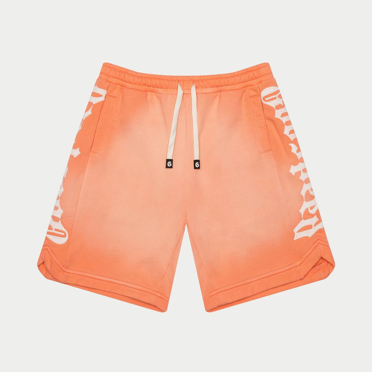 Orange shorts with white graphics on a light gray background