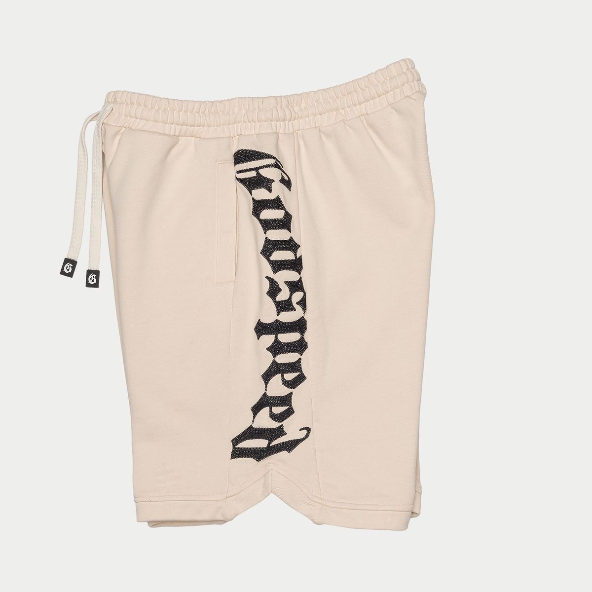 Beige shorts with black logo on a white background
