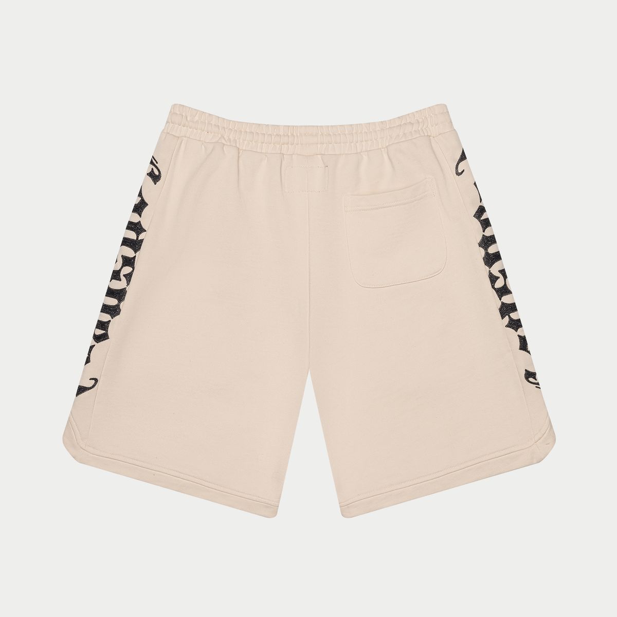Beige shorts with black and white pattern on a light gray background
