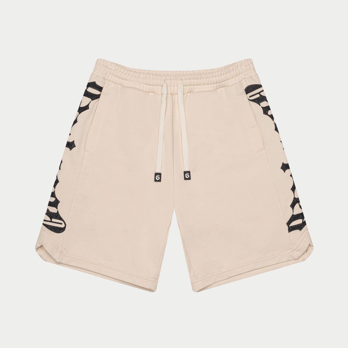 Beige shorts with black and white pattern on a light gray background
