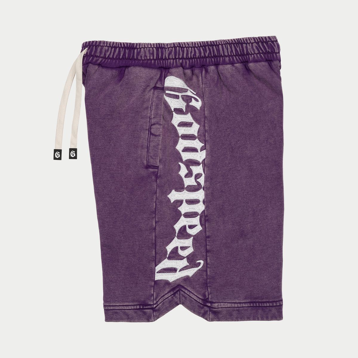 Purple shorts with a white logo on a light gray background