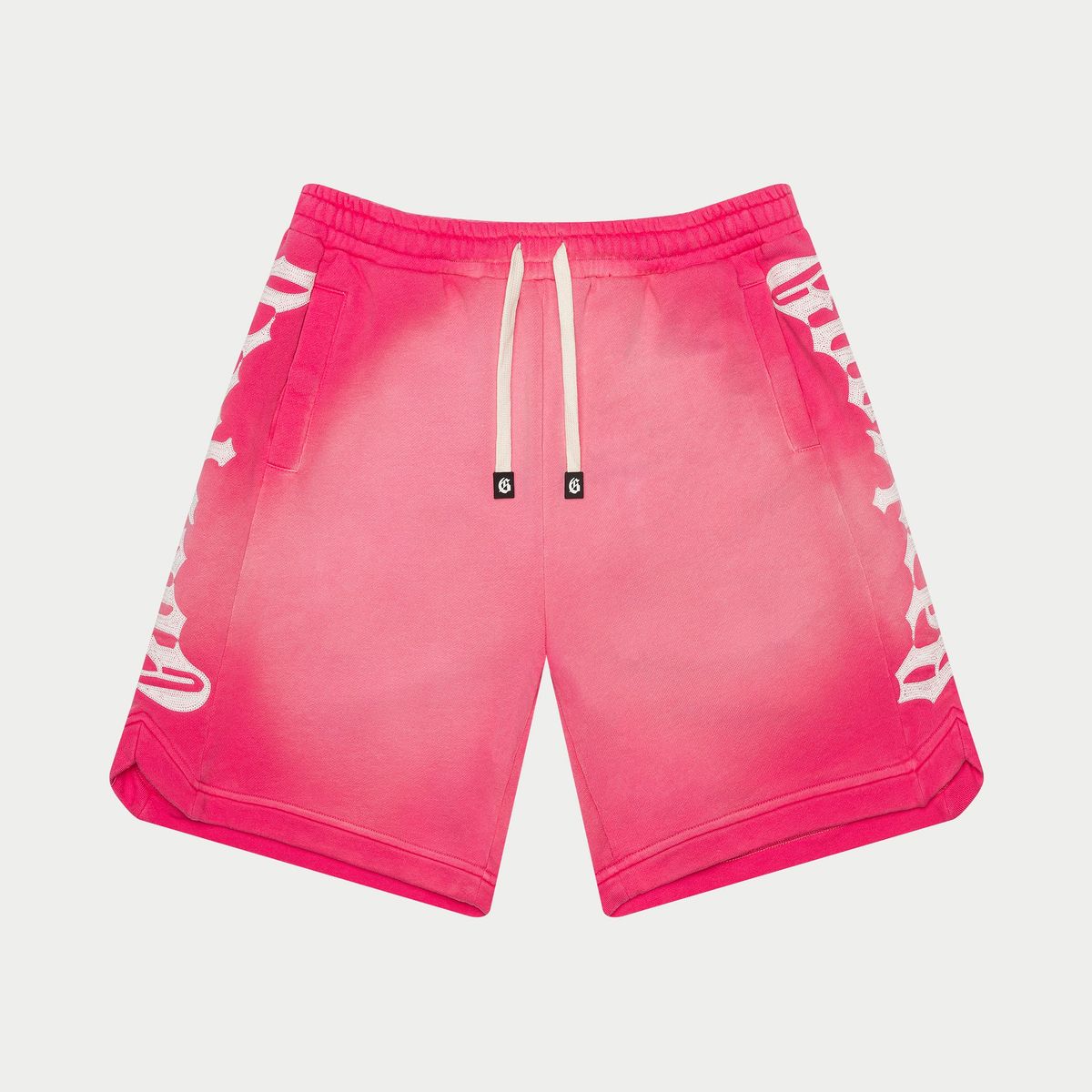 Pink shorts with white logo on a light gray background