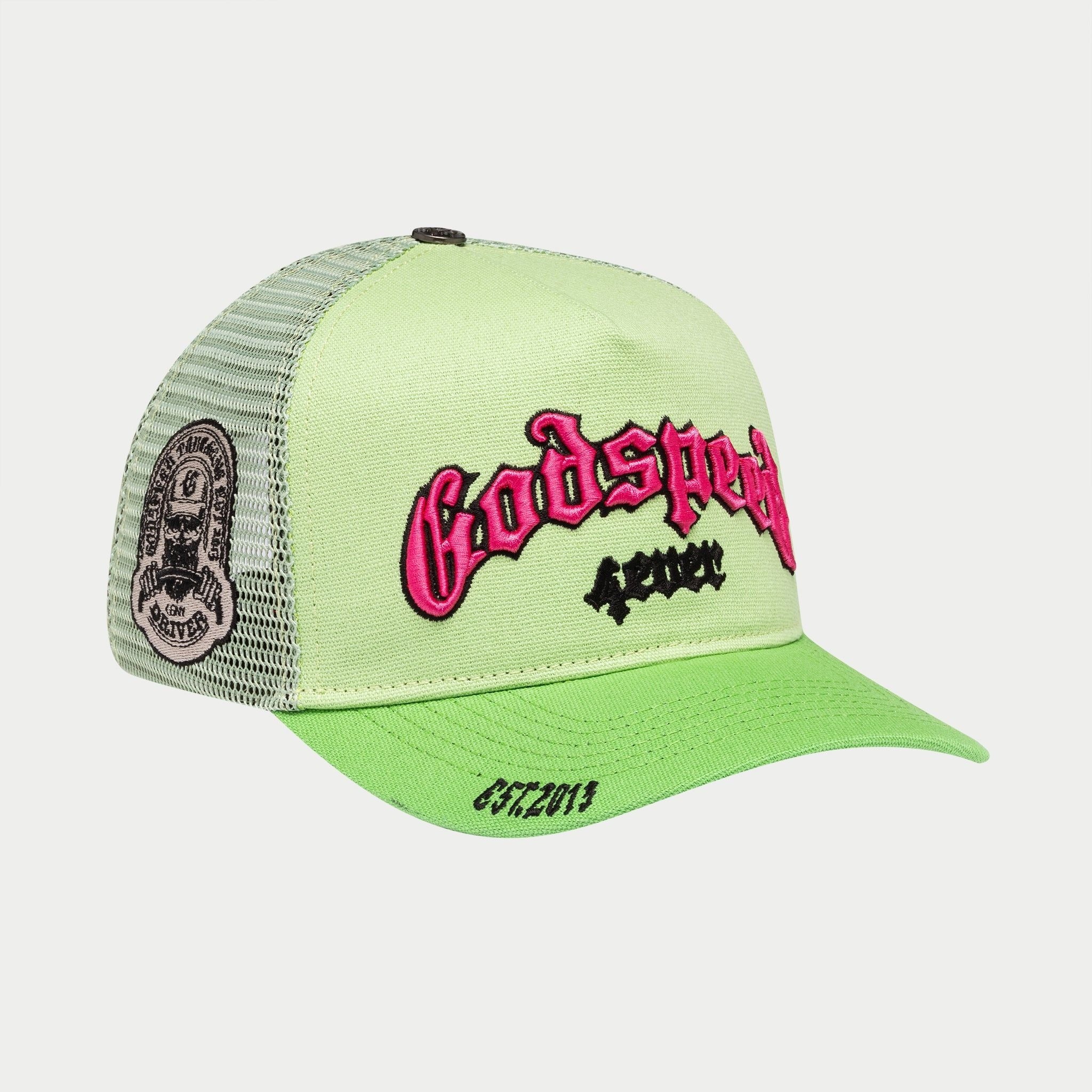Green trucker cap with pink and black text on a white background