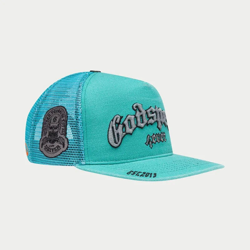 Godspeed 4ever Signature Trucker Hat titled "The Mother of All Truckers" featuring color-changing embroidery, limited edition box, and 3-piece pin set.
