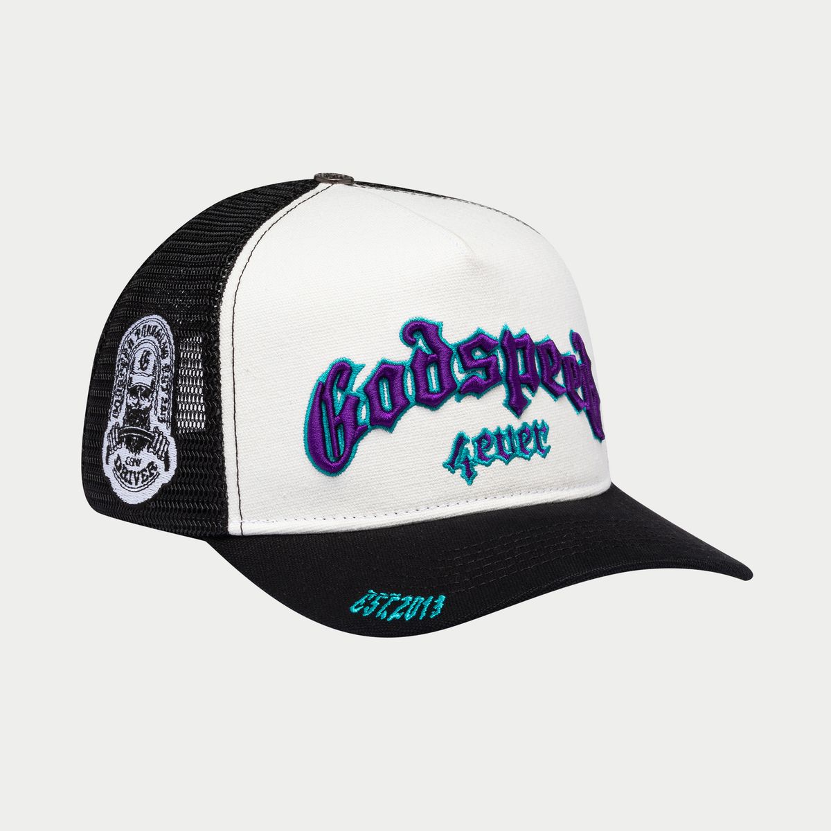 Trucker hat in white/black/purple with color-changing Godspeed logo, mesh back, and collectible pins, packaged in a custom box.
