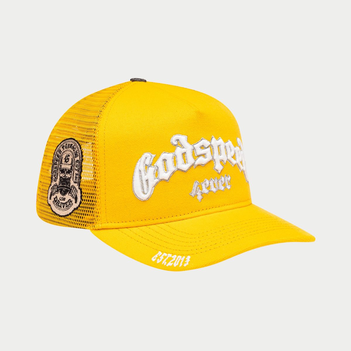  White and yellow trucker hat with color-shifting embroidery, packaged in a custom Godspeed box with a 3-piece collectible pin set.