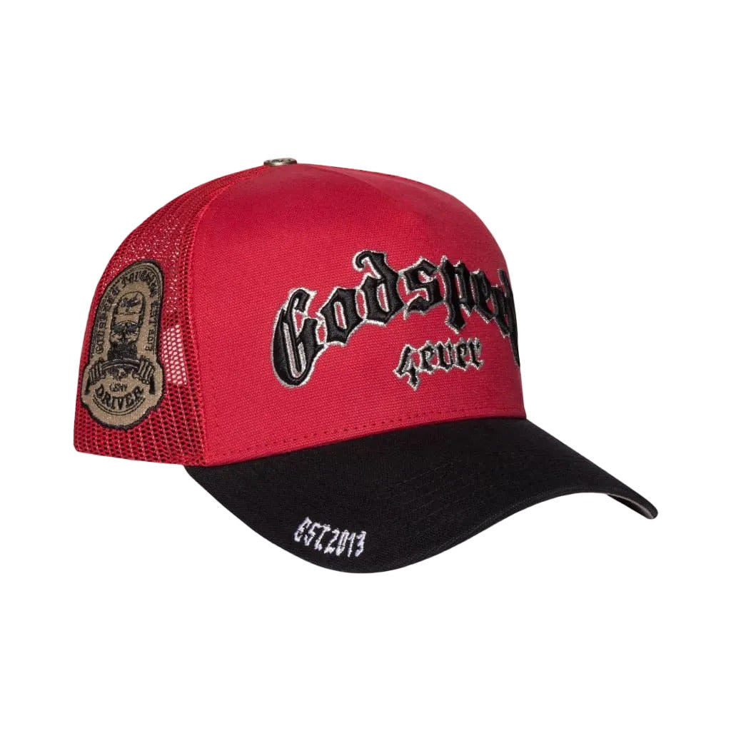 Godspeed GS Forever trucker hat in red and black featuring color-changing embroidery, mesh-back construction, collectible pin set, and limited-edition packaging.
