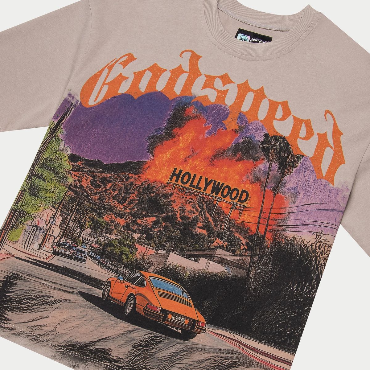 T-shirt with a graphic design of a car, Hollywood sign, and mountains on a beige background