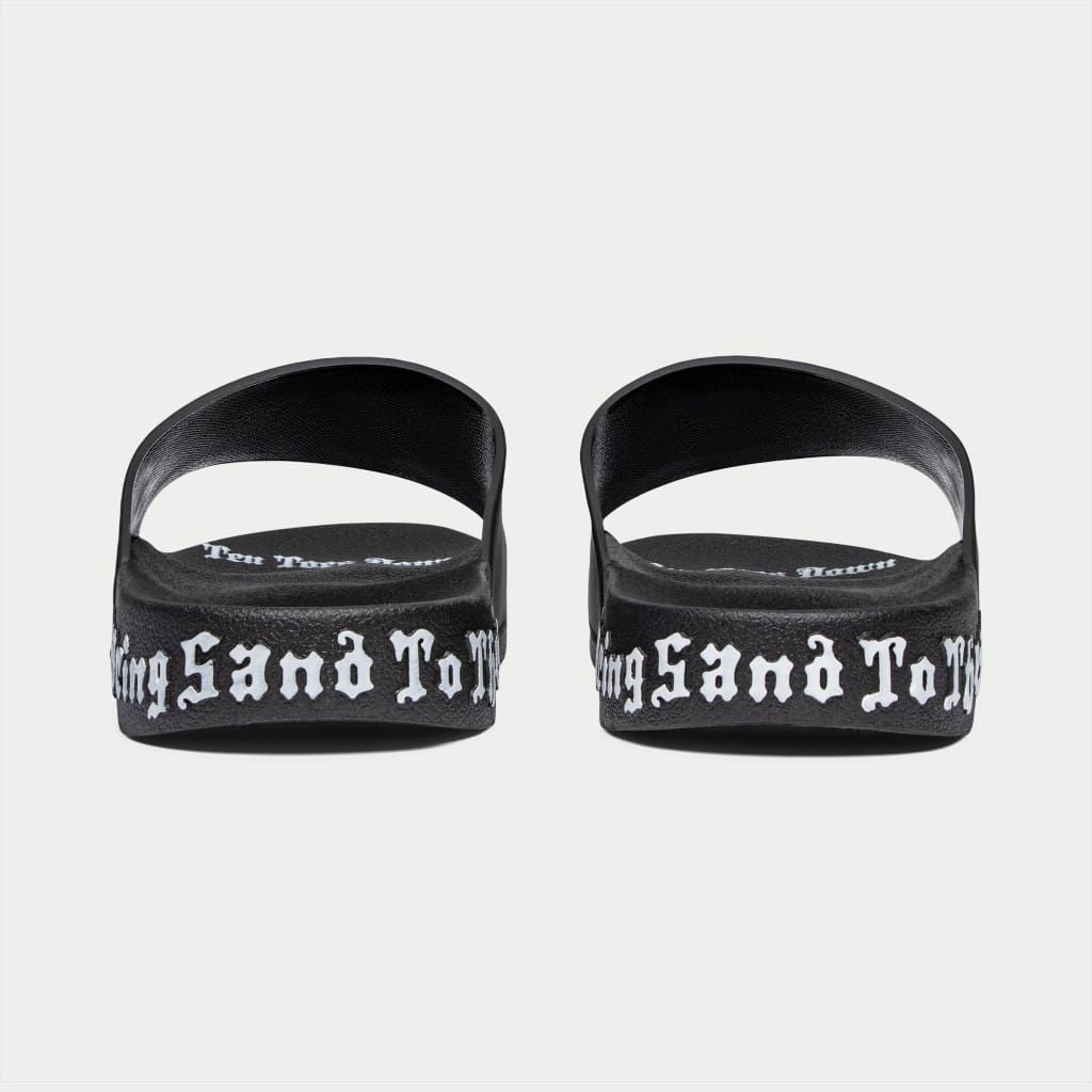 Black Godspeed OG Logo Slides featuring “DON’T BRING SAND TO THE BEACH” tagline with branded box and dust bag.