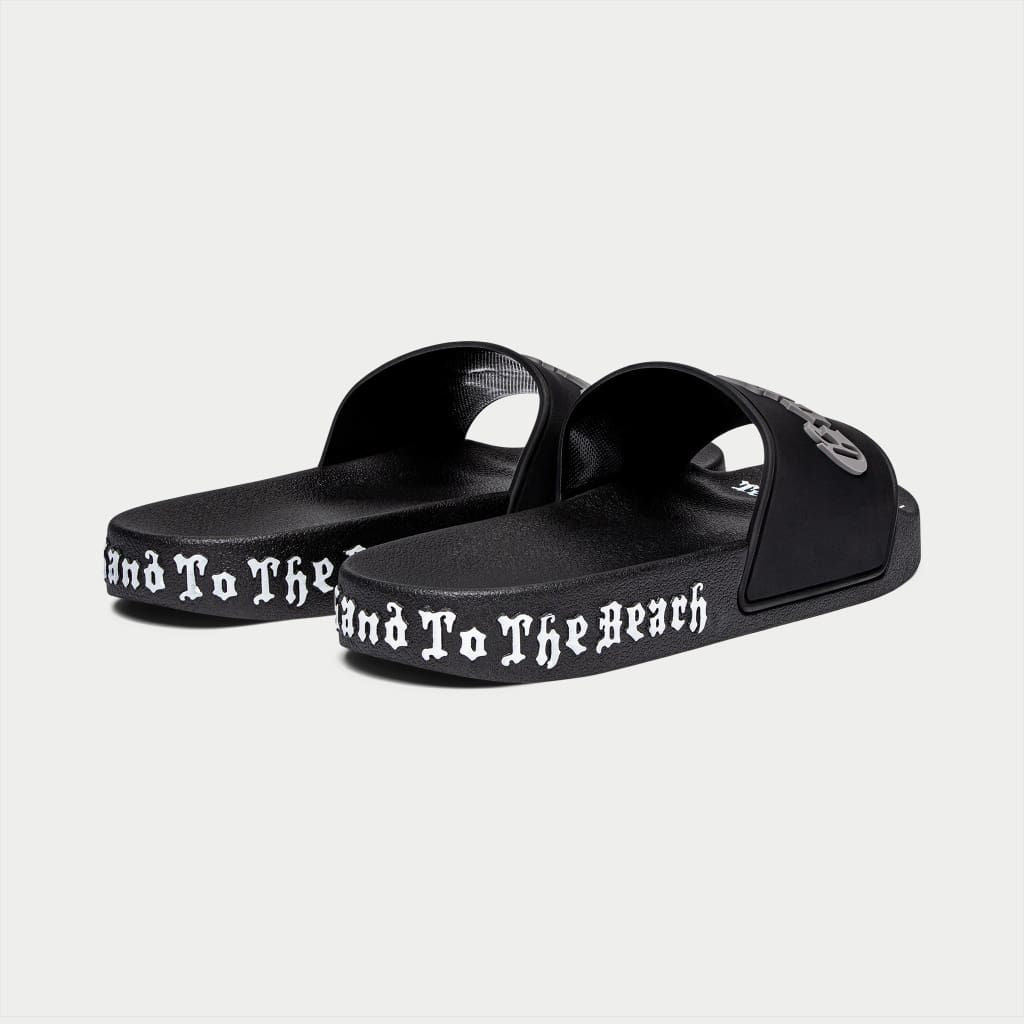 Black Godspeed OG Logo Slides featuring “DON’T BRING SAND TO THE BEACH” tagline with branded box and dust bag.