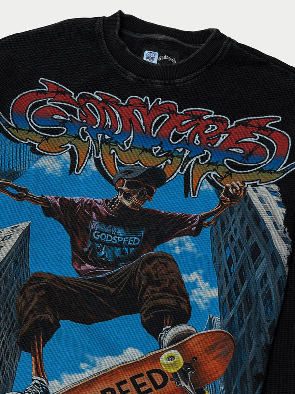 Black t-shirt with a graphic design of a skeleton skateboarder and colorful text on a cityscape background.
