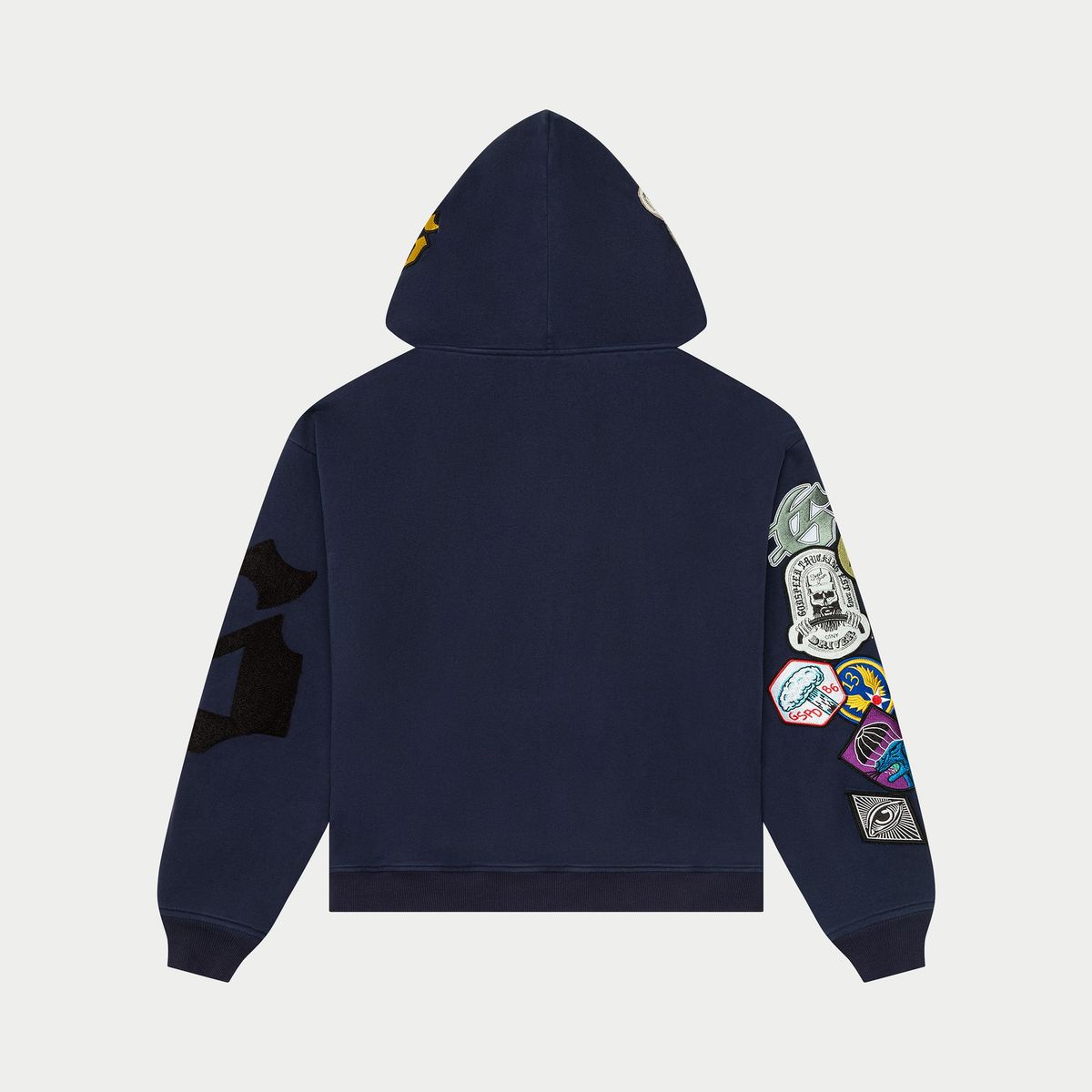 The GS Squadron Hoodie in Navy delivers a clean mix of comfort and utility. Made from medium-weight 100% cotton, it offers a soft, breathable feel ideal for everyday wear. Distinctive patch details on the sleeve and hood give it a signature Godspeed look, adding character without sacrificing simplicity. Finished with a full zip front and a relaxed fit, this hoodie brings effortless style to any rotation.