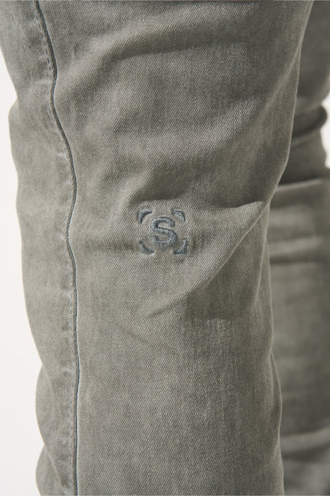 SERENEDE® HAVENMIST grey overdyed stacked jeans with stretch material, fitted construction, extended length, stacked ankle finish, leather waistband patch, and branded hardware