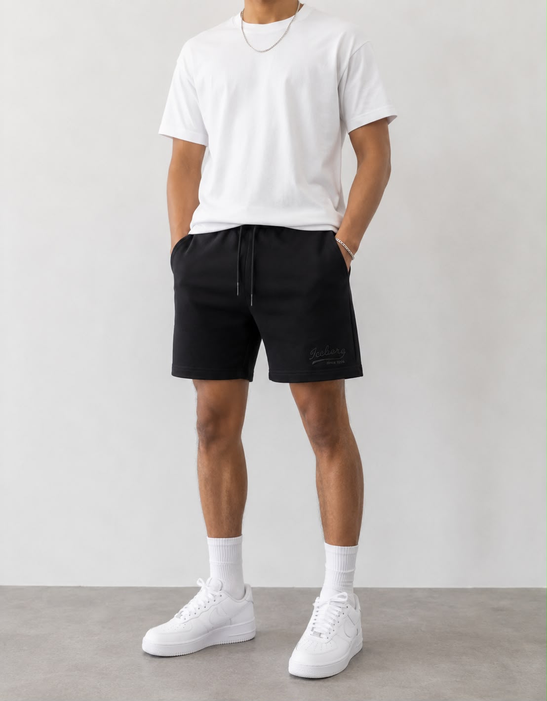 Men’s black embroidered logo shorts featuring premium stitched logo detail, relaxed fit, and modern streetwear styling.