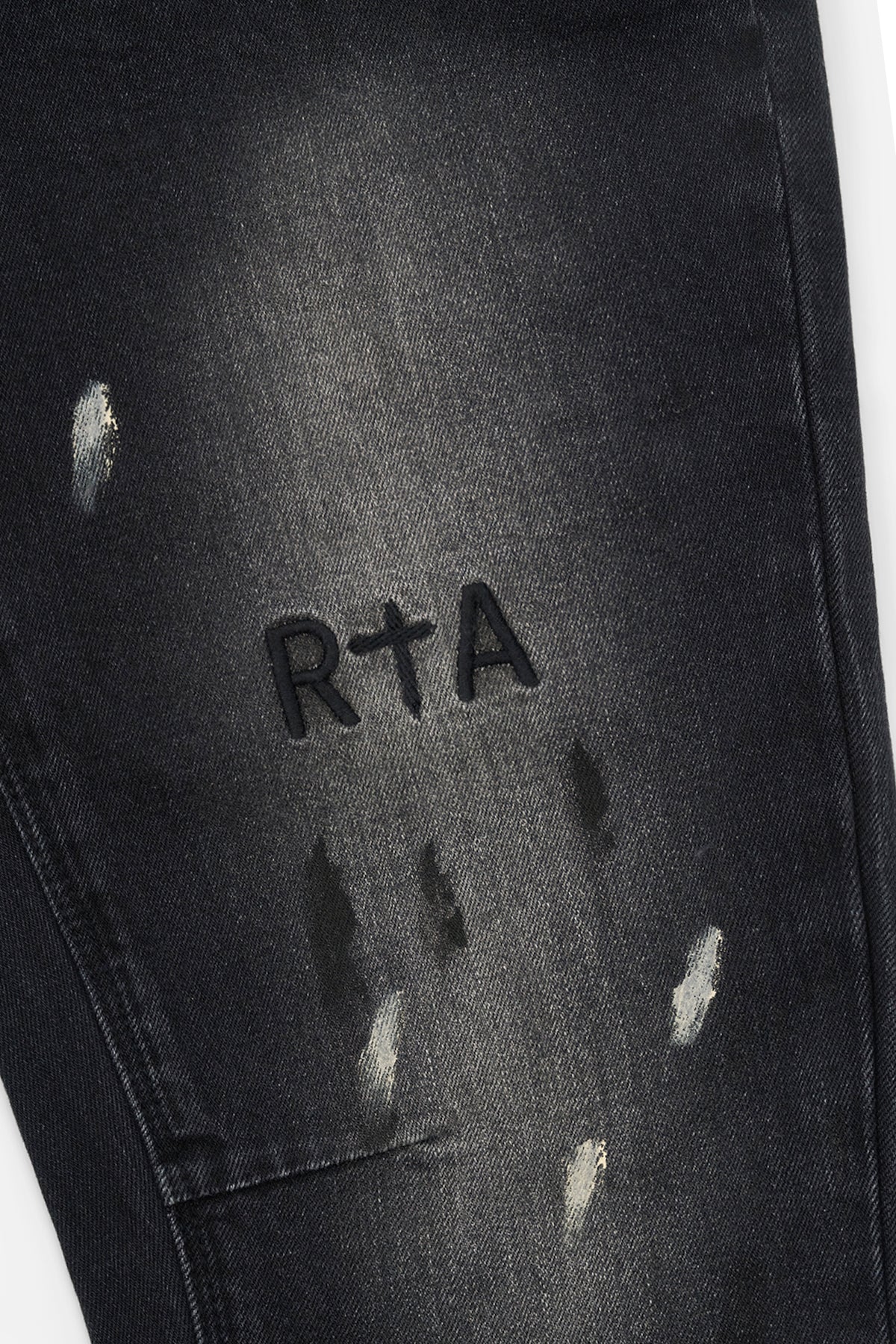 RTA Bryant Skinny Jean in Inkstone Paint with faded wash, paint splatter, and RtA signature detailing.