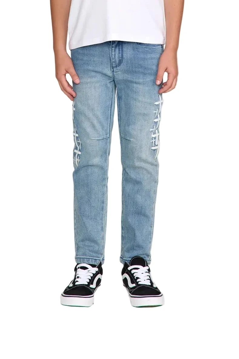 RtA Benson skinny jeans in Coastal Drift with embroidered cross patches and RtA logo on the back pocket.