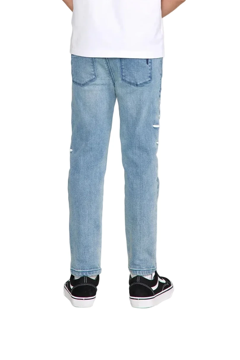 RtA Benson skinny jeans in Coastal Drift with embroidered cross patches and RtA logo on the back pocket.