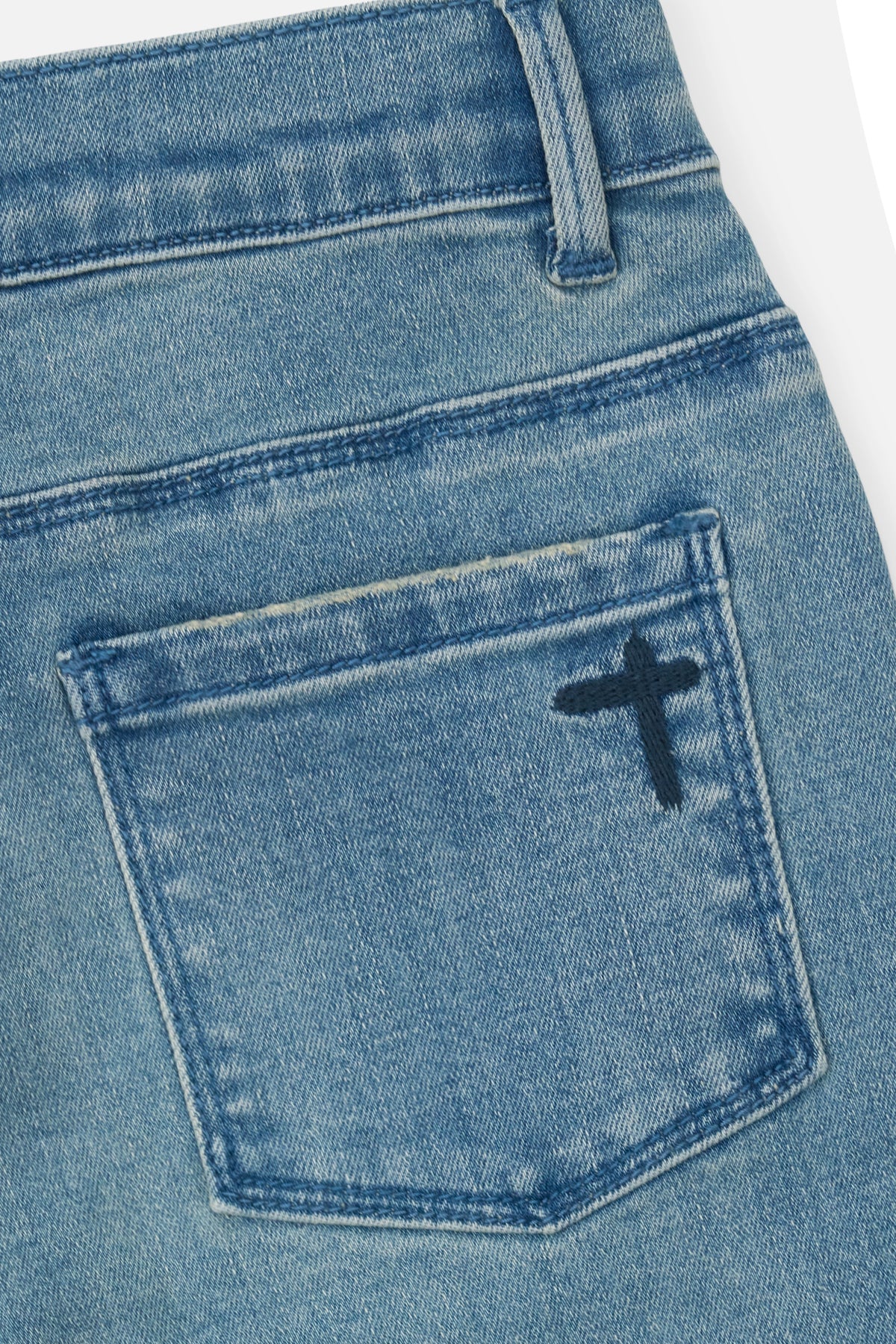 RtA Benson skinny jeans in Coastal Drift with embroidered cross patches and RtA logo on the back pocket.