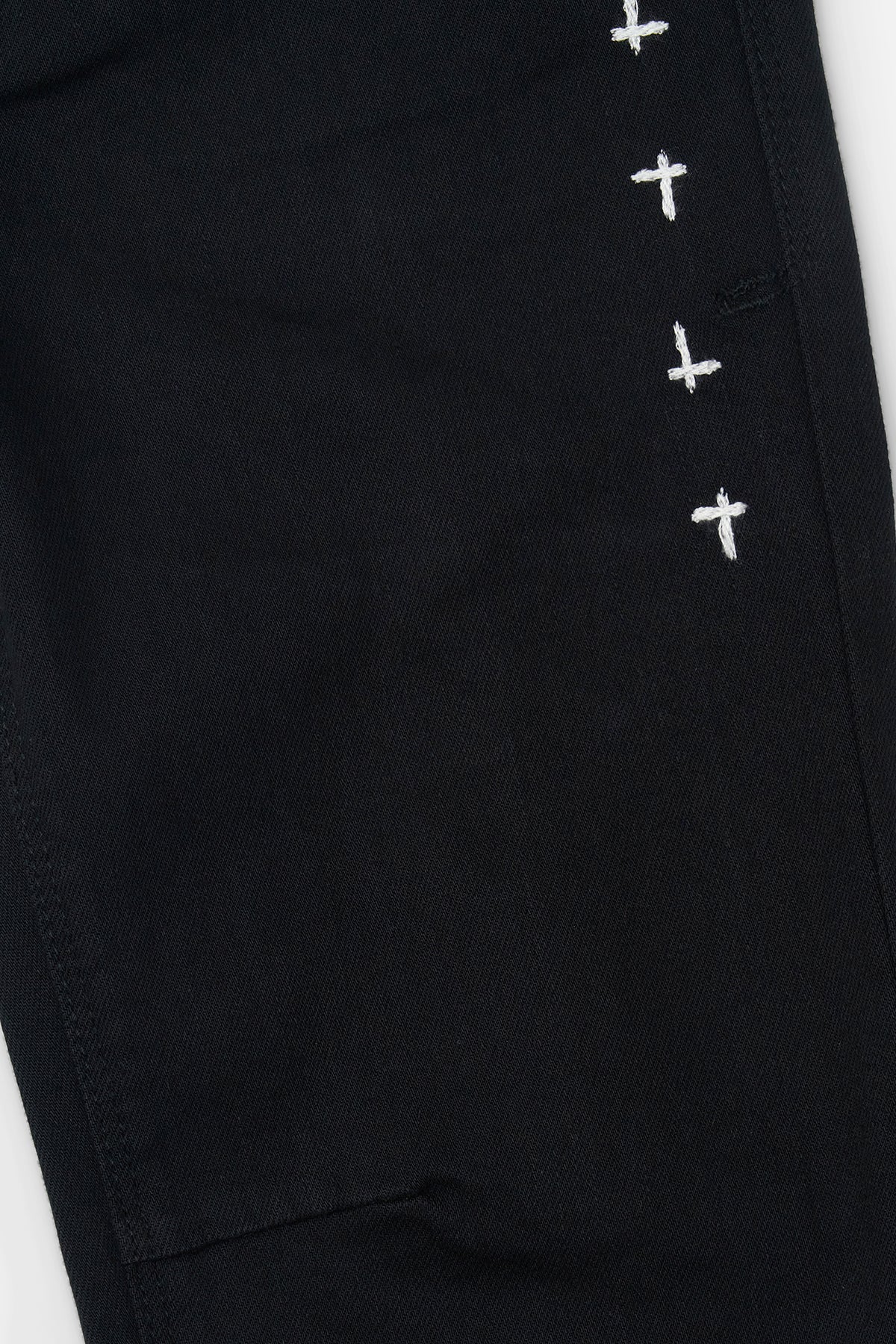 RtA Carlo skinny jeans in black multi cross with cross embroidery and pin-tuck dagger seams.